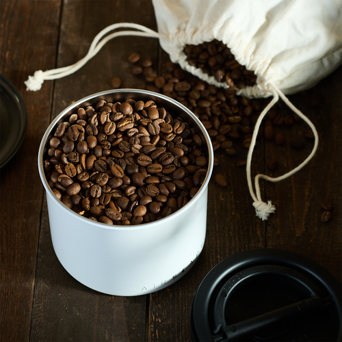 White Airscape canister full of coffee beans
